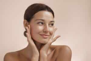 Beauty portrait of woman with clear, healthy skin, showcasing results of microneedling treatment for skin rejuvenation and texture improvement.