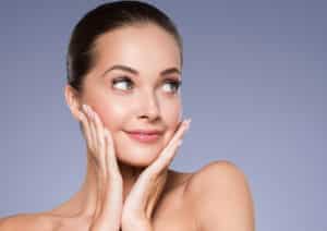 Woman with healthy skin smiling after microdermabrasion facial treatment, showcasing beauty, skincare, and cosmetic rejuvenation results