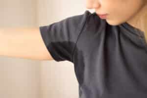Woman with excessive underarm sweating from hyperhidrosis.
